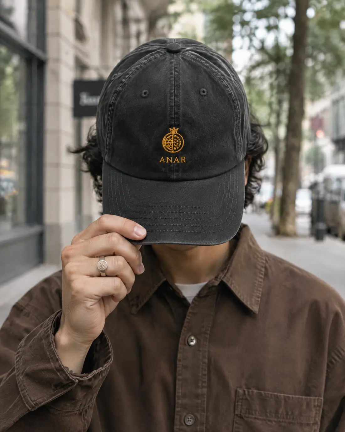 The Pomegranate cap held up in the street